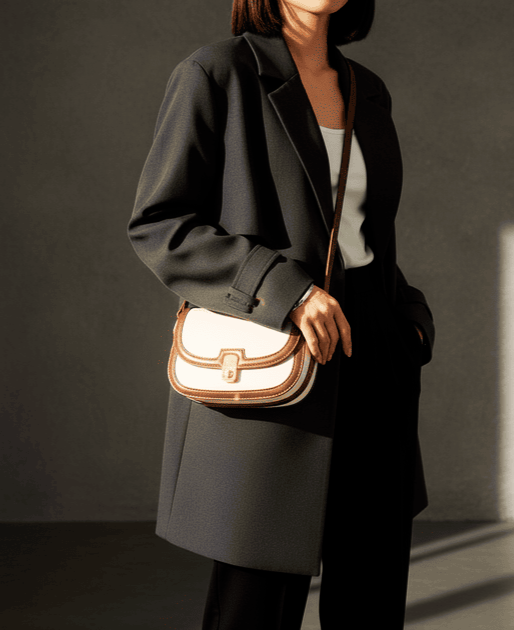 Home Woman in a dark blazer with a cream and brown crossbody bag